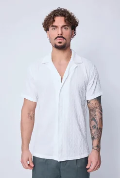 Chemise unie manches courtes à motifs géométriques