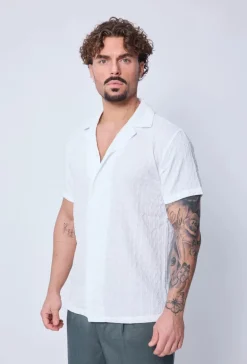 Chemise unie manches courtes à motifs géométriques