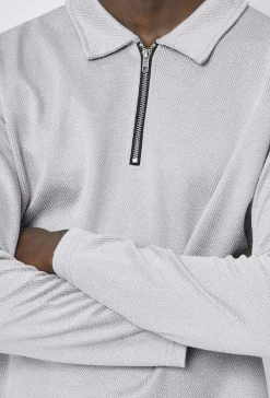 Polo couleur uni manche longue à zip